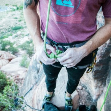 Someone getting ready to climb rocks